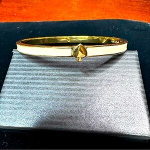 Kate spade  cream enameled skinny hinged bracelet with spade clasp